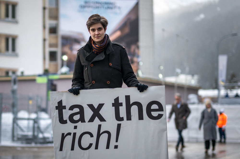 (Files) Austrian Marlene Engelhorn poses with a placard reading 