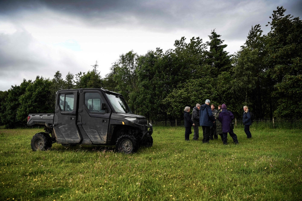 Members of the public take part in a guided tour to see beavers by a pond near Doune, Perthshire, Scotland, on June 16, 2024. (Photo by Andy Buchanan / AFP)
