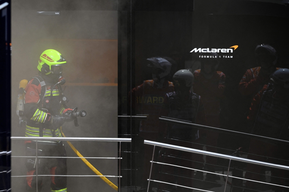 Firefighters work to extinguish a fire at McLaren motor-home at the Circuit de Catalunya on June 22, 2024 in Montmelo, on the outskirts of Barcelona, during the Spanish Formula One Grand Prix. (Photo by Josep Lago / AFP)