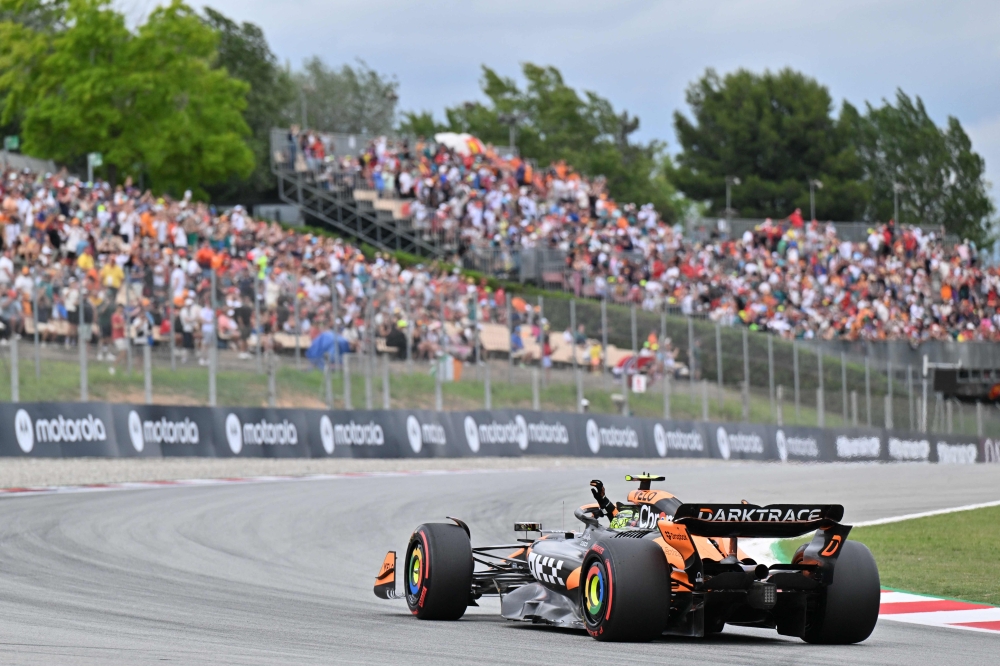 McLaren's British driver Lando Norris celebrates getting the pole position after the qualification session at the Circuit de Catalunya on June 22, 2024 in Montmelo, on the outskirts of Barcelona, during the Spanish Formula One Grand Prix. (Photo by Manaure Quintero / AFP)
