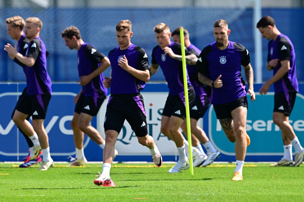 Germany's defender #06 Joshua Kimmich (C-L) runs during a MD-1 training session at the team's base camp in Herzogenaurach, on the eve of their Euro 2024 Group A football match against Switzerland, on June 22, 2024. (Photo by Tobias Schwarz / AFP)