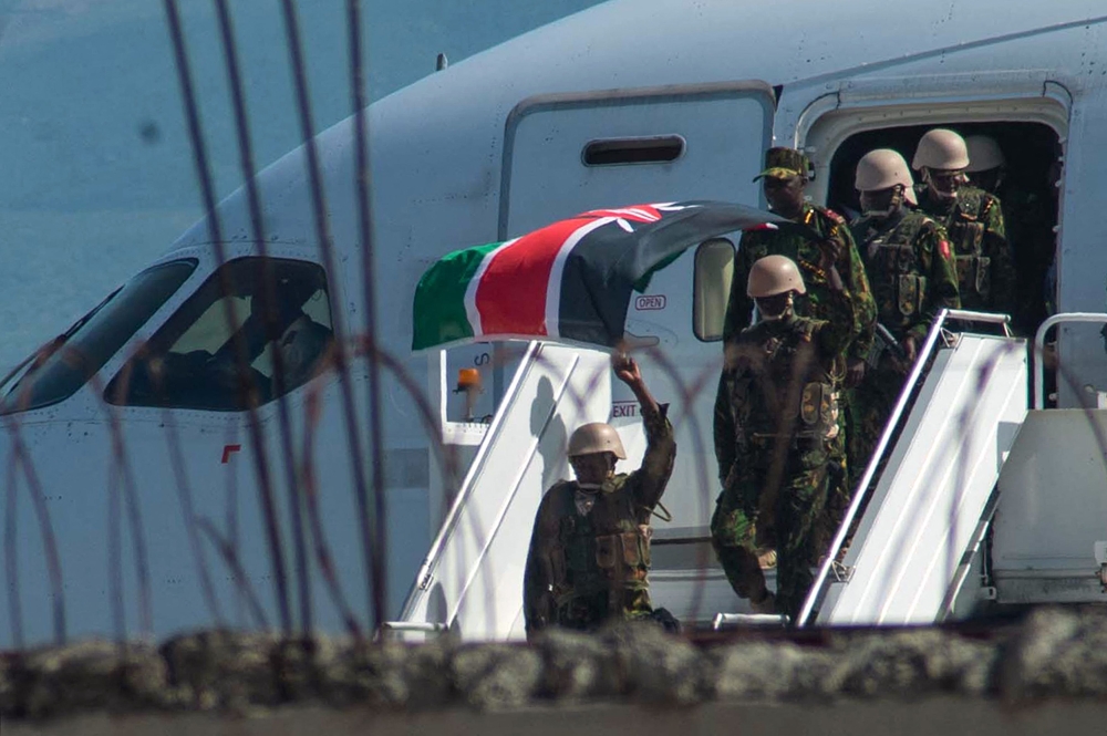 Kenyan security forces arrive at Toussaint Louverture International Airport in Port-au-Prince on June 25, 2024 (Photo by Clarens Siffroy / AFP)