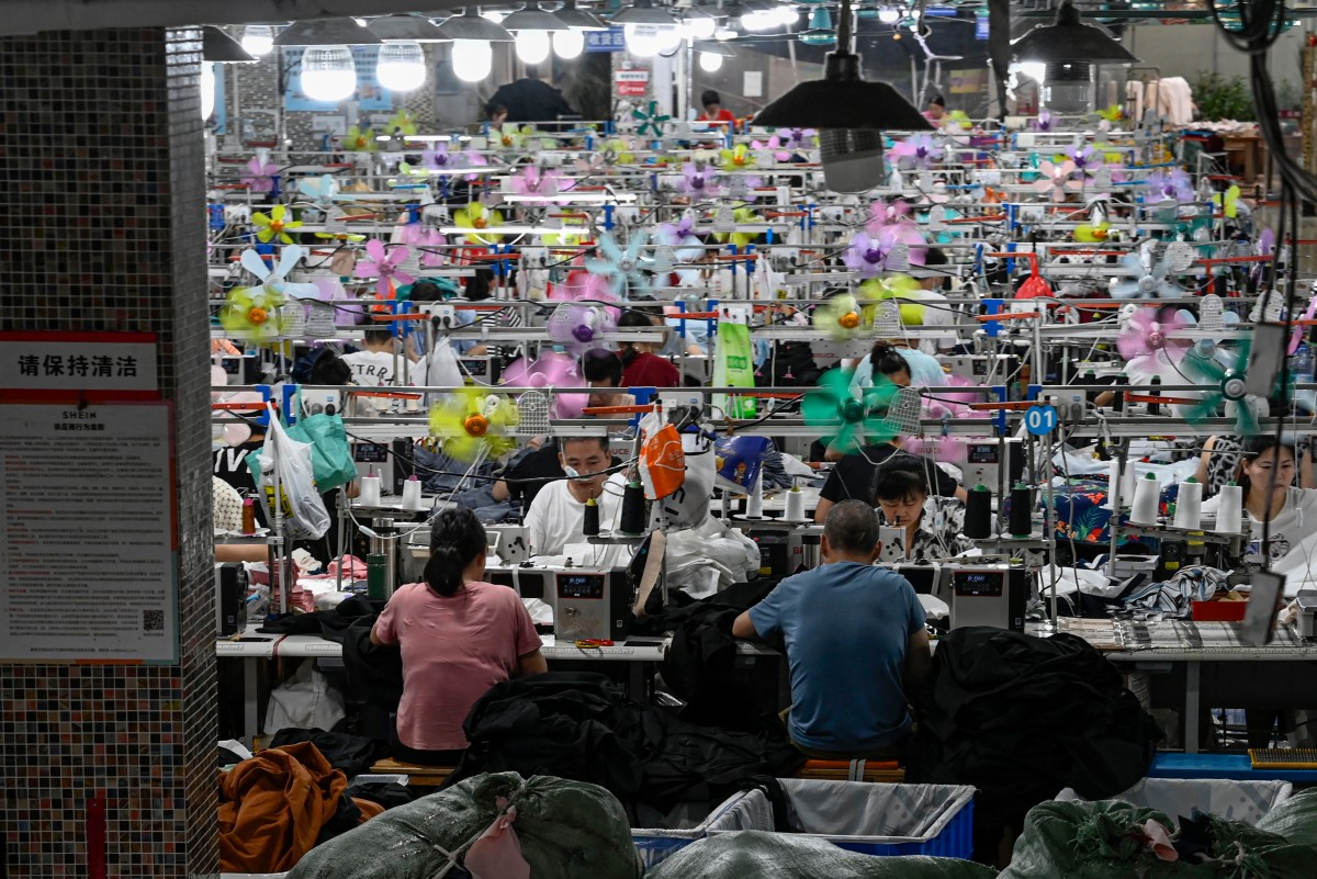 This photo taken on June 11, 2024 shows workers producing garments at a textile factory that supplies clothes to fast fashion e-commerce company Shein in Guangzhou in southern China's Guangdong province. Photo by Jade GAO / AFP.