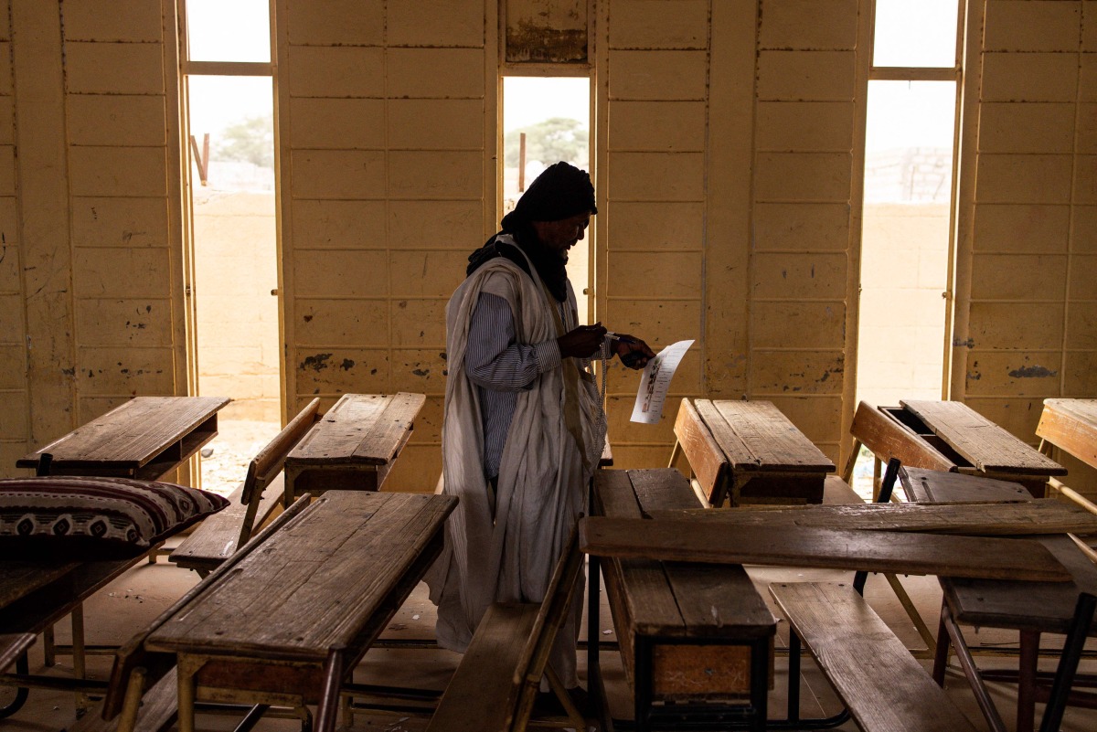 A voter prepares to mark his ballot at a voting station in Nouakchott on June 29, 2024. (Photo by JOHN WESSELS / AFP)
