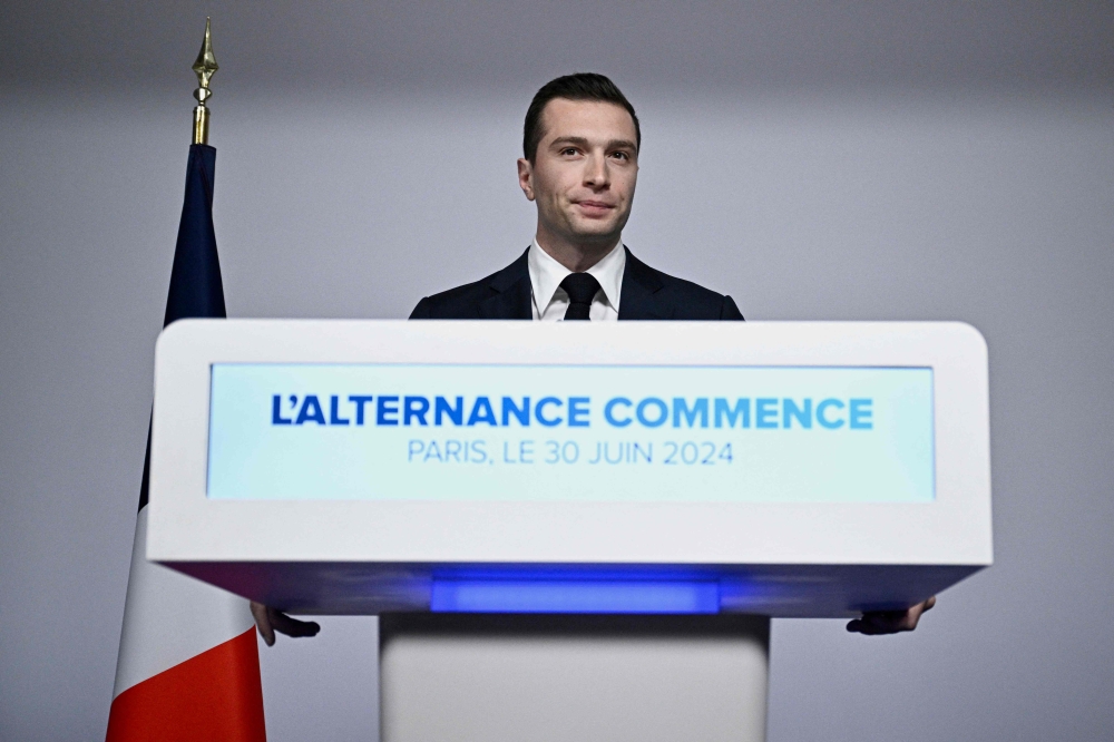 French far-right Rassemblement National (RN) political party President and lead MEP Jordan Bardella gives a speech during the results evening of the first round of the parliamentary elections in Paris on June 30, 2024. (Photo by JULIEN DE ROSA / AFP)
