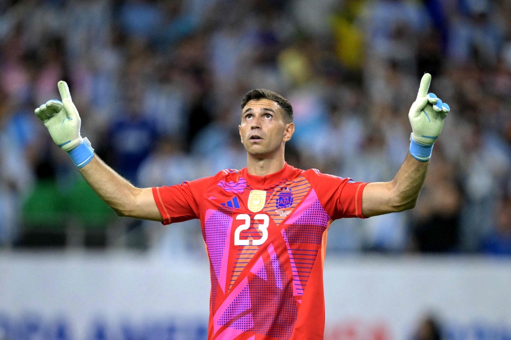 Argentina's goalkeeper #23 Emiliano Martinez celebrates after saving a goal during a penalty shoot out on July 4, 2024. (Photo by Juan Mabromata / AFP)
