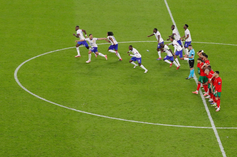 France's players celebrate after winning the UEFA Euro 2024 quarter-final football match between Portugal and France at the Volksparkstadion in Hamburg on July 5, 2024. (Photo by Ronny HARTMANN / AFP)

