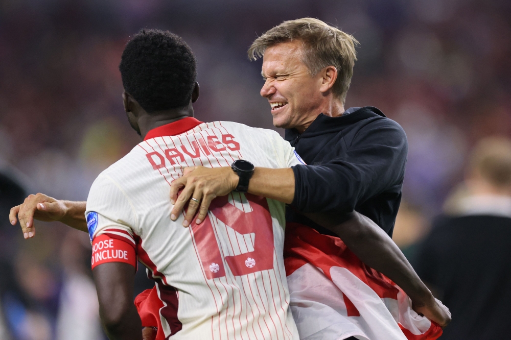 Alphonso Davies of Canada celebrates with Jesse Marsch, Head Coach of Canada after the CONMEBOL Copa America 2024 quarter-final match on July 05, 2024. Ron Jenkins/Getty Images/AFP 