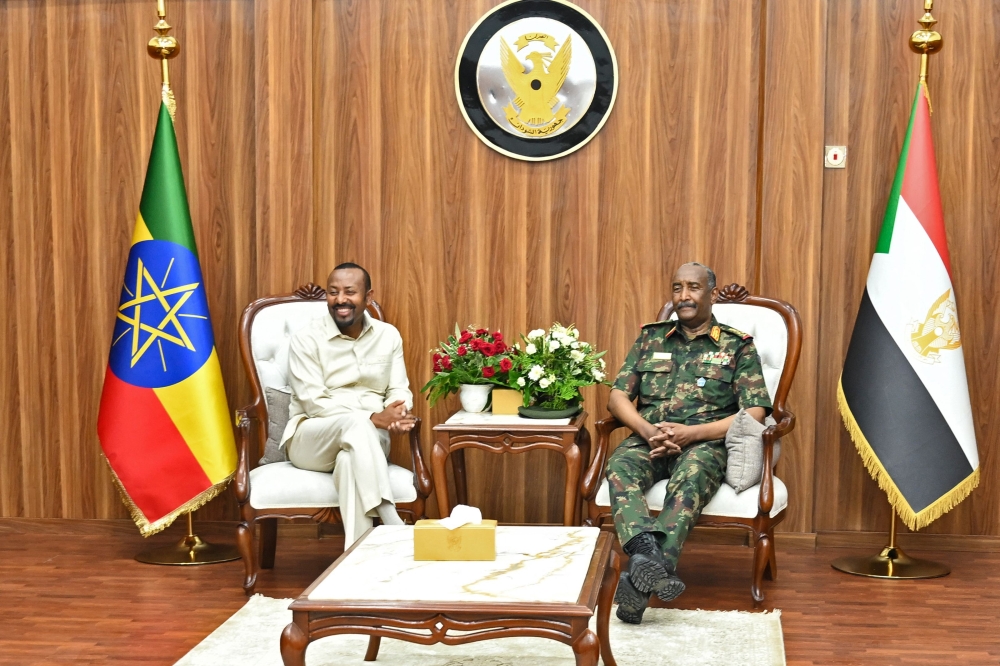 The President of Sudan's Transitional Sovereignty Council (TSC) General Abdel Fattah al-Burhan (R) meets with Ethiopia's Prime Minister Abiy Ahmed during an official visit in Port Sudan on July 9, 2024. (Photo by AFP)
