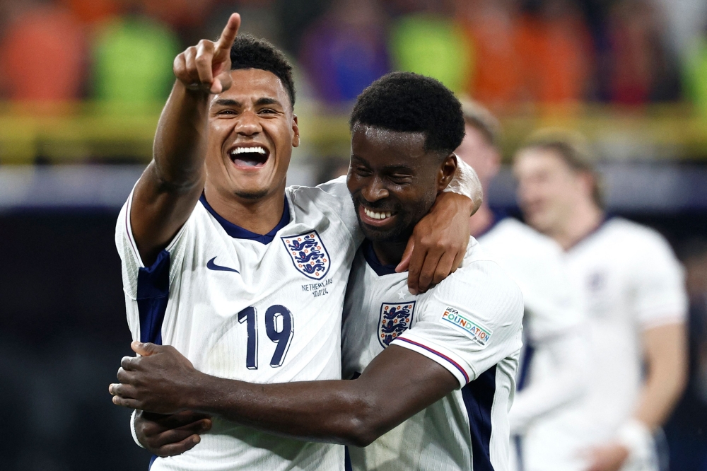 England's forward #19 Ollie Watkins (L) and England's defender #06 Marc Guehi celebrate after winning the UEFA Euro 2024 semi-final football match on July 10, 2024. (Photo by Kenzo Tribouillard / AFP)