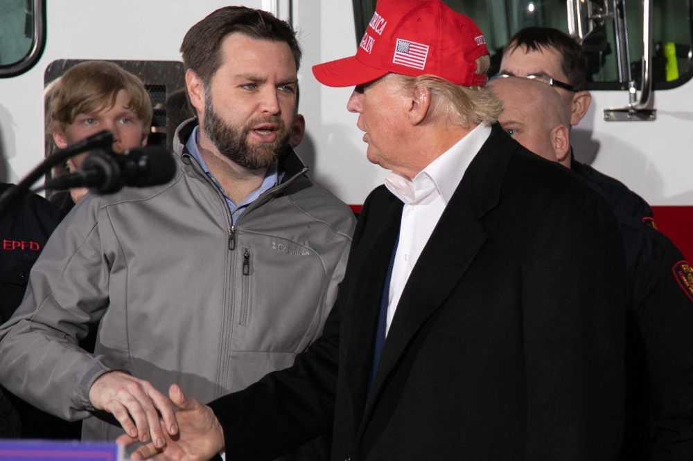 (FILES) US Senator JD Vance (R-OH) (L) shakes hands with former US President Donald Trump during an event at the East Palestine Fire Department in East Palestine, Ohio, on February 22, 2023. July 15, Trump announces Ohio Senator J.D. Vance as running mate (Photo by Rebecca DROKE / AFP)
