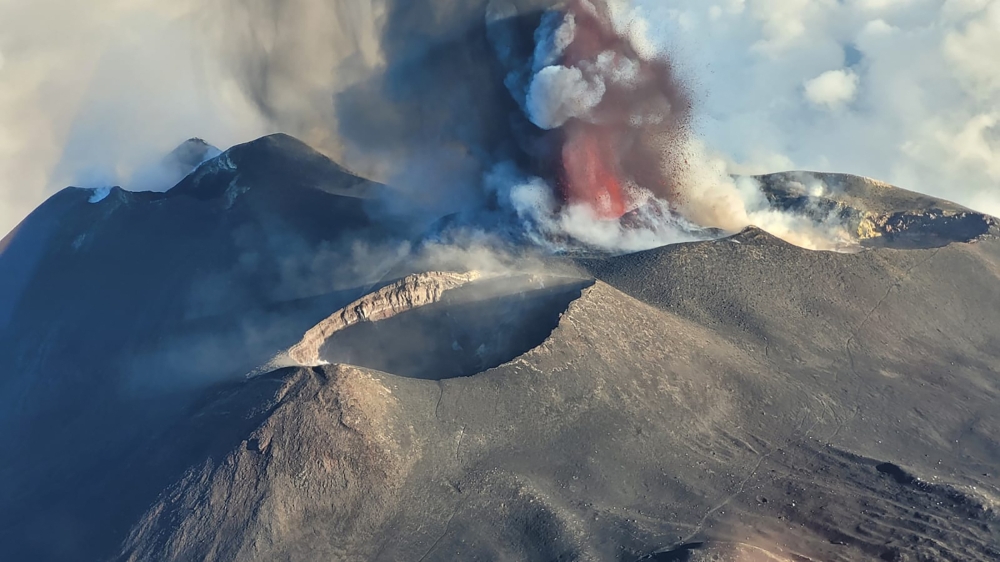 (Files) A picture shows the eruption of the Mount Etna volcano on July 4, 2024 in Sicily. (Photo by Giuseppe Distefano / various sources / AFP)

 