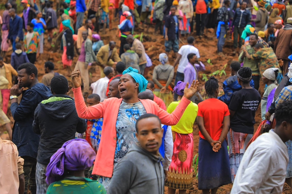 This grab made from a handout footage released by the Gofa Zone Government Communication Affairs Department on July 23, 2024, shows people standing at the bottom of a landslide that occurred in the Geze-Gofa district. (Photo by Gofa Zone Government Communication Affairs Department/ESN / AFP)


