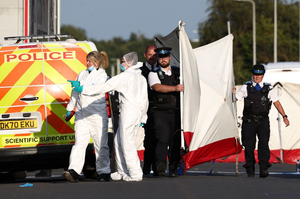 Police officers and forensic personnel put up a fence on Hart Street in Southport, northwest England, on July 29, 2024, following a knife attack. Photo by Darren Staples / AFP