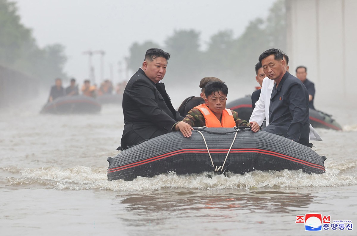 This recent undated photo released by North Korea's official Korean Central News Agency (KCNA) via KNS on July 31, 2024 shows North Korea's leader Kim Jong Un riding in a dingey through flood waters as he inspects the area for damage after record-breaking heavy rains on July 29 in the city of Sinuiju in North Pyongan Province. Photo by KCNA VIA KNS / AFP.