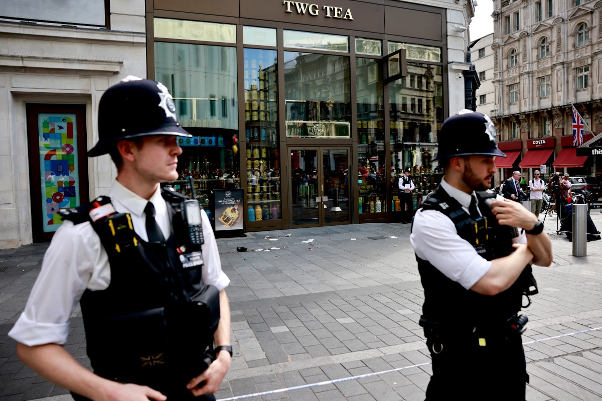 A photograph taken on August 12, 2024 shows police officers standing by a cordoned off area in Leicester square, London. Photo by BENJAMIN CREMEL / AFP.
