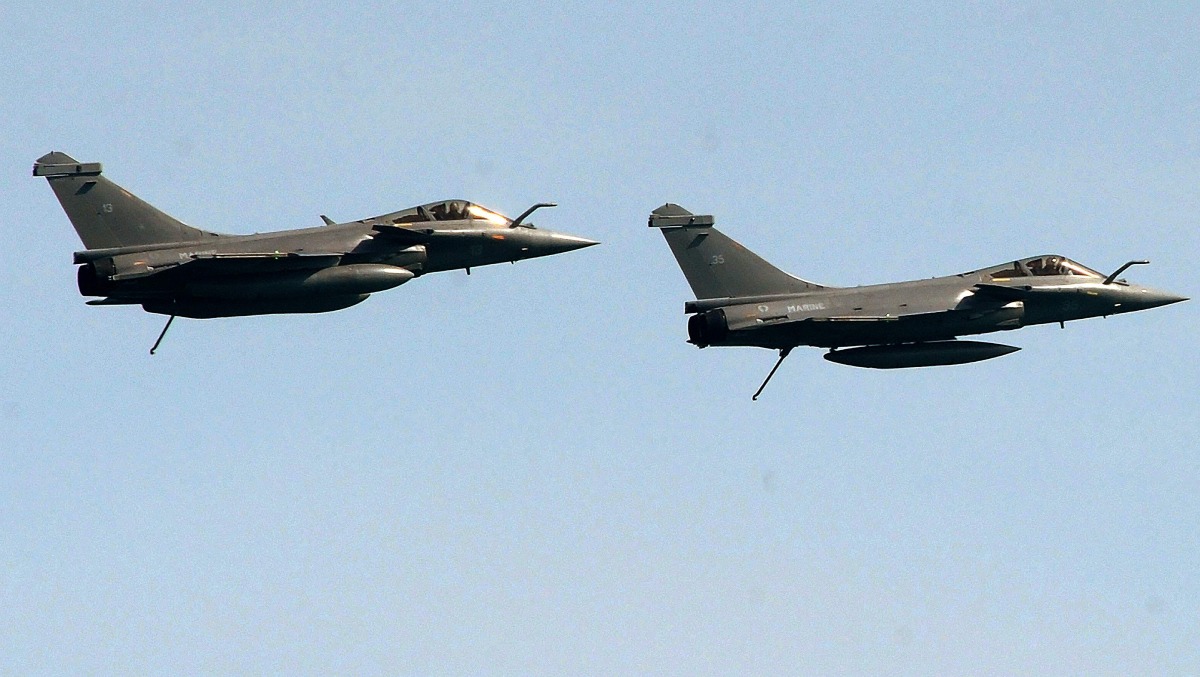 (FILES) Two French Rafales jet fighters fly during an international military exercise with Indian navy on May 11, 2017 off the coasts of Brest, western France. (Photo by FRED TANNEAU / AFP)