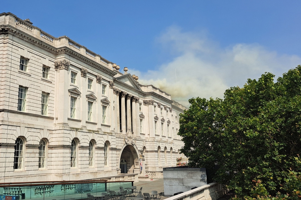 Smoke is seen rising into the sky from a fire located in the roof of Somerset House beside the River Thames in London on August 17, 2024. Photo by James RYBACKI / AFP