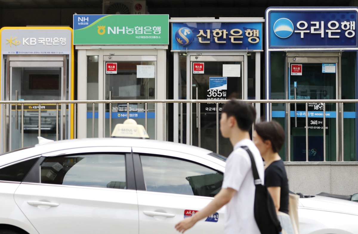 Automated teller machines of local commercial banks are lined up on a street in Seoul, S Korea.
