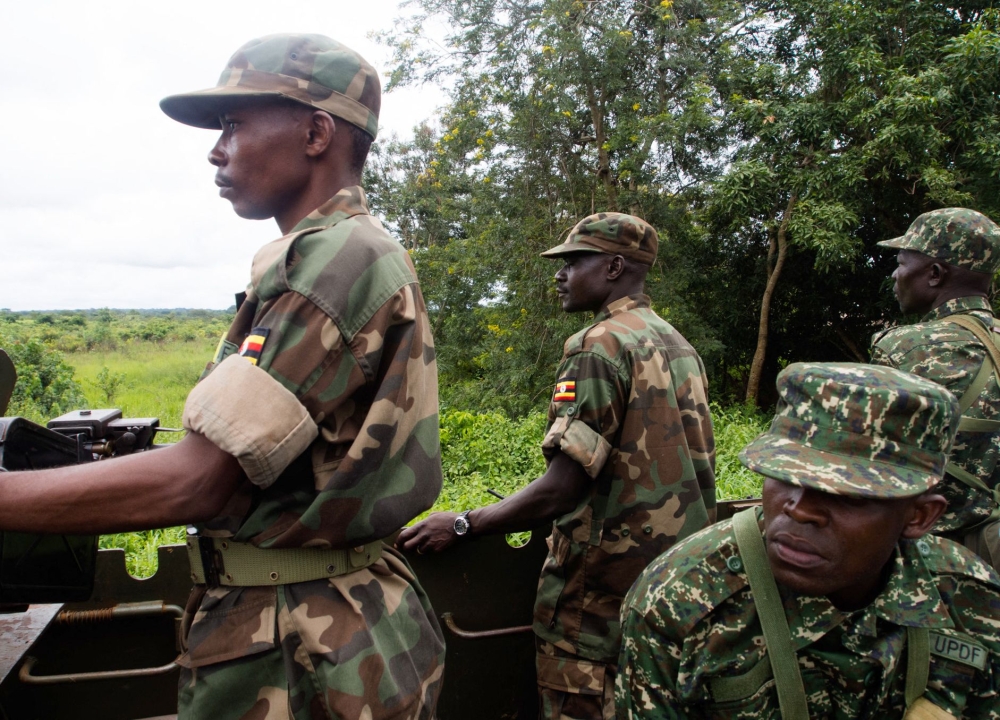 (FILES) Soldiers of the Uganda People's Defence Force (UPDF) patrol in Zemio, in the northeastern part of the Central African Republic to secure the area from rebel groups' possible attacks, on June 25, 2014. (Photo by Michele SIBILONI / AFP)

