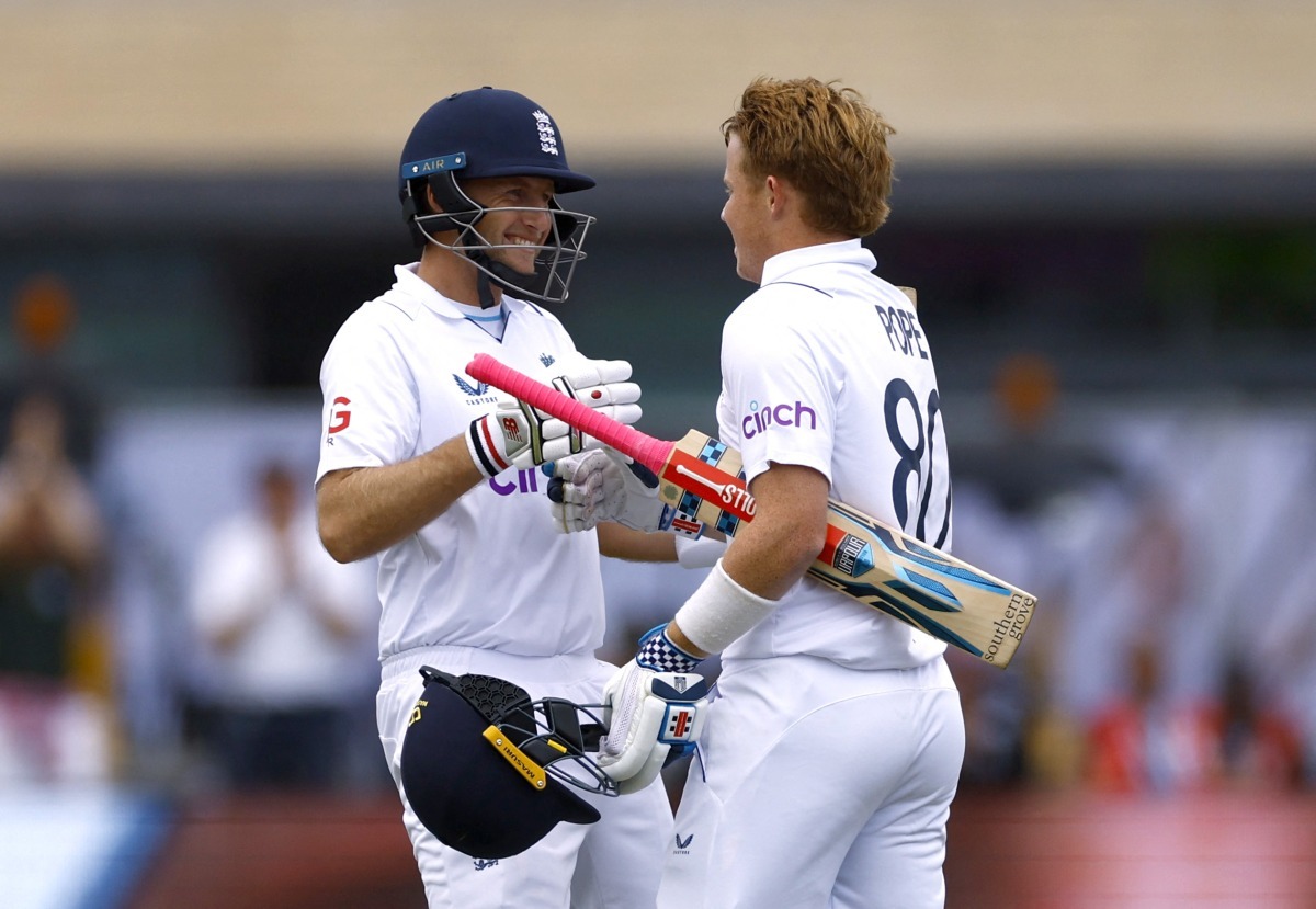 England's Ollie Pope celebrates reaching his century with Joe Root Action Images via Reuters/Andrew Boyers