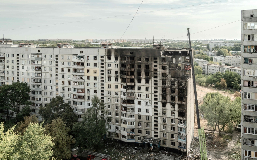 This photograph taken on August 31, 2024 shows a heavily damaged residential building following a recent missile attack in Kharkiv. (Photo by Ivan SAMOILOV / AFP)
