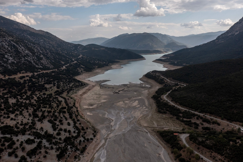 This aerial photograph shows the low water level of the Mornos artificial lake following a drought, near the village of Lidoriki, about 240 km northwest of Athens, on September 1, 2024. Photo by Angelos TZORTZINIS / AFP