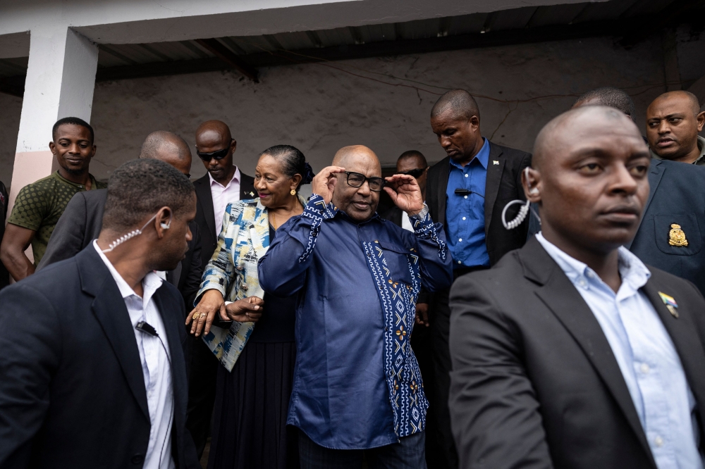 File: Incumbent Comoros President and presidential candidate for the Convention for the Renewal of the Comoros (CRC) party, Azali Assoumani (ccentre right), and Ambari Assoumani, First Lady of Comoros, leave after casting their ballots at the Mitsudje public school polling station in Moroni on January 14, 2024. (Photo by Olympia De Maismont / AFP)
