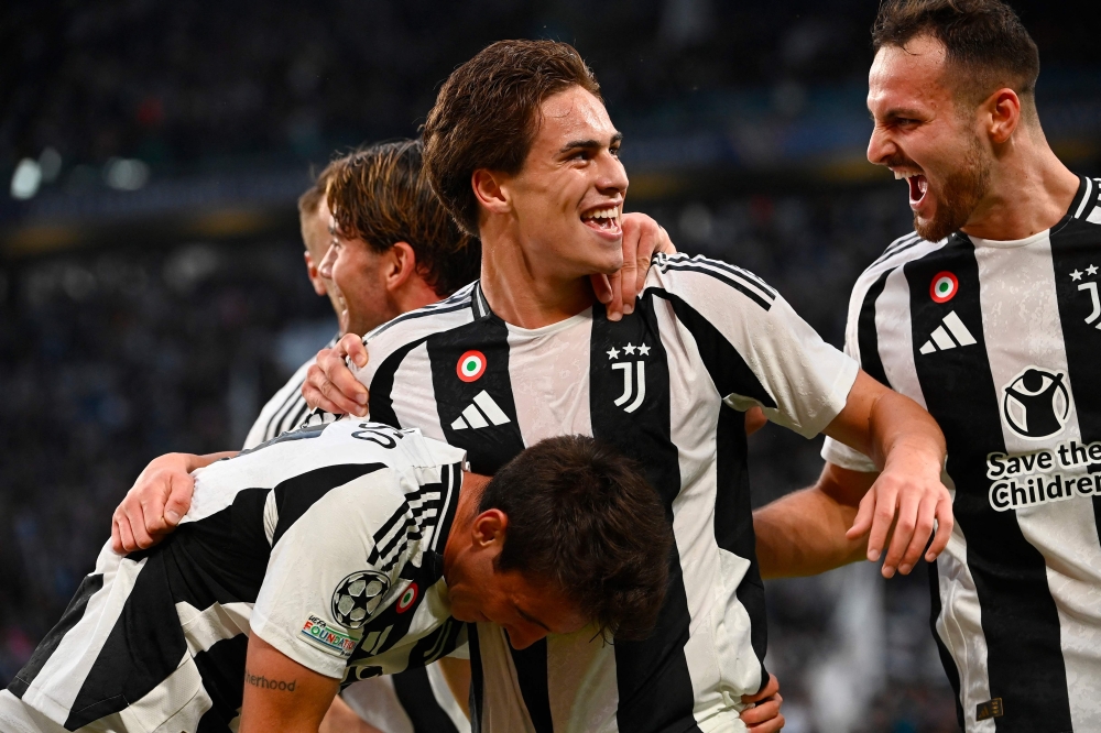 Juventus' Turkish forward #10 Kenan Yildiz (centre) celebrates scoring his team's first goal during the UEFA Champions League 1st round day 1 football match between Juventus FC and PSV Eindhoven, at the Juventus Stadium in Turin on September 17, 2024. (Photo by Isabella Bonotto / AFP)