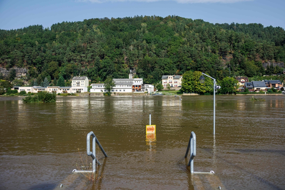 A signpost standing in the floods of the Elbe river indicates the way to the ferry in Krippen, eastern Germany on Septemer 17, 2024. (Photo by Jens Schlueter / AFP)
 