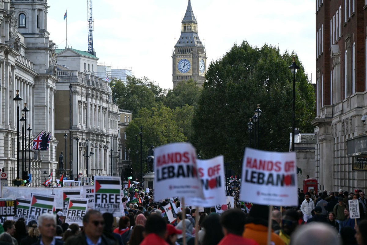 Pro-Palestinian activists and supporters wave flags and hold placards as they pass through central London, during a March for Palestine on October 5, 2024. Photo by JUSTIN TALLIS / AFP.