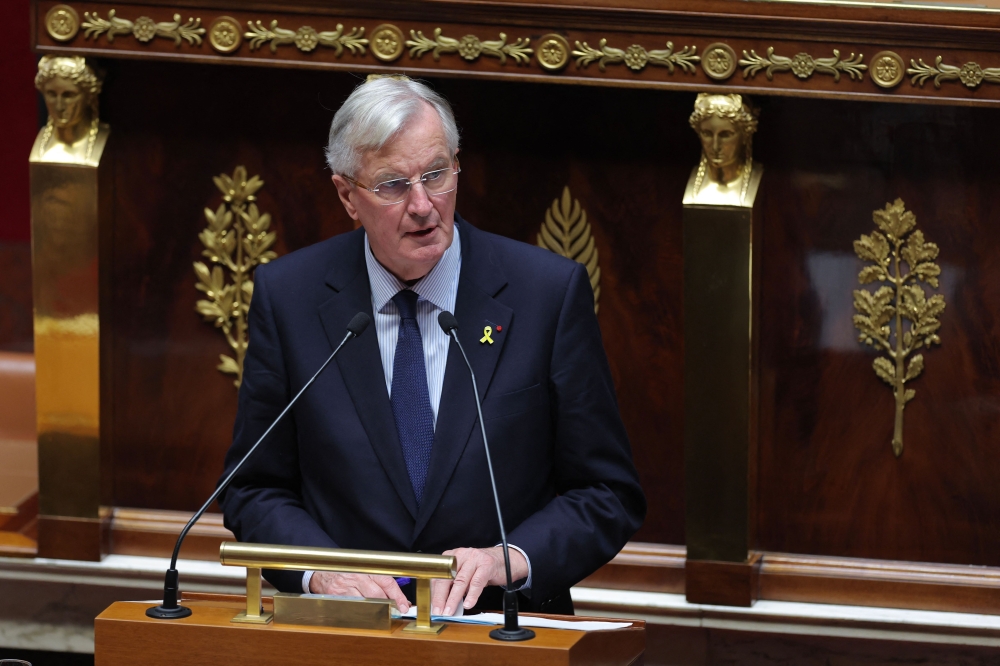 French Prime Minister Michel Barnier delivers a speech during a vote on no confidence motion during a parliamentary session at The National Assembly in Paris on October 8, 2024. (Photo by Thomas Samson / AFP)