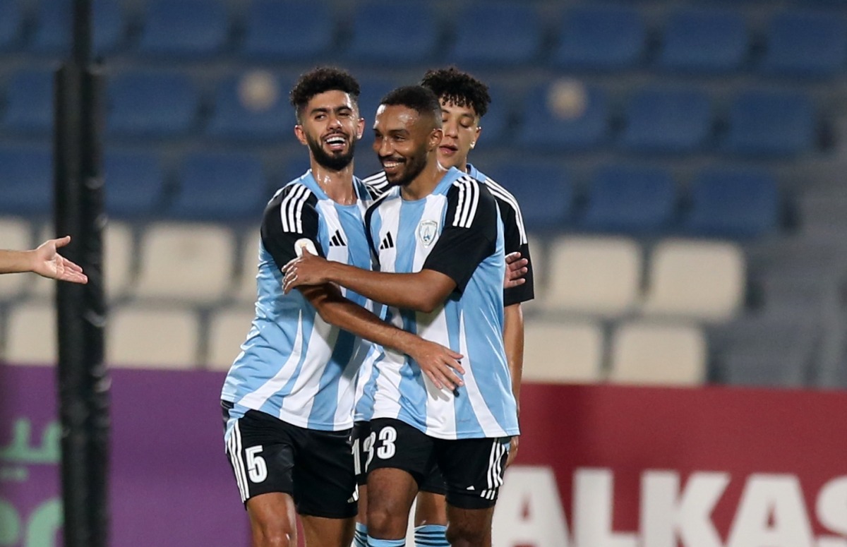 Al Wakrah’s Moayad Hassan (centre) celebrates with teammates after scoring team’s first goal. 
