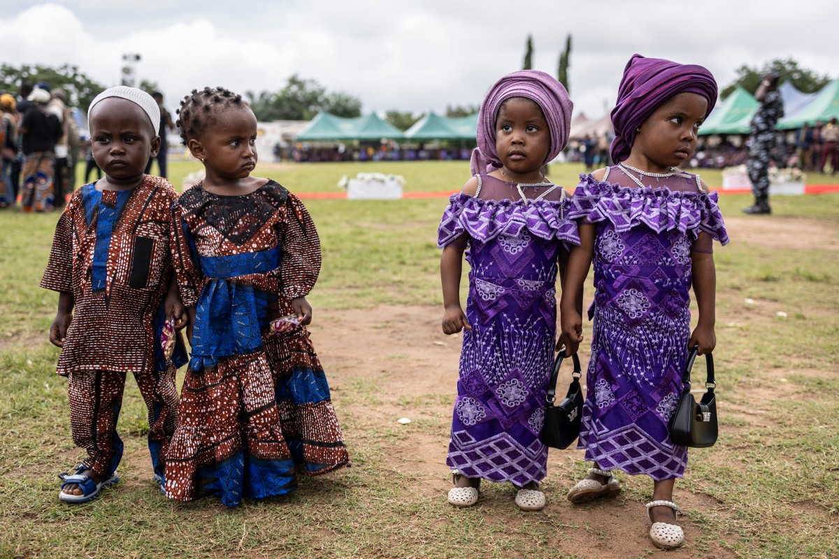 Twins pose for a photograph during the Igboora World Twins Festival 2024, in Igbo-Ora on October 12, 2024. Nigeria’s self-proclaimed ‘twins capital of the world’ Igbo-Ora holds its annual festival to celebrate the town’s unusually high incidence of multiple births. Photo by OLYMPIA DE MAISMONT / AFP.
