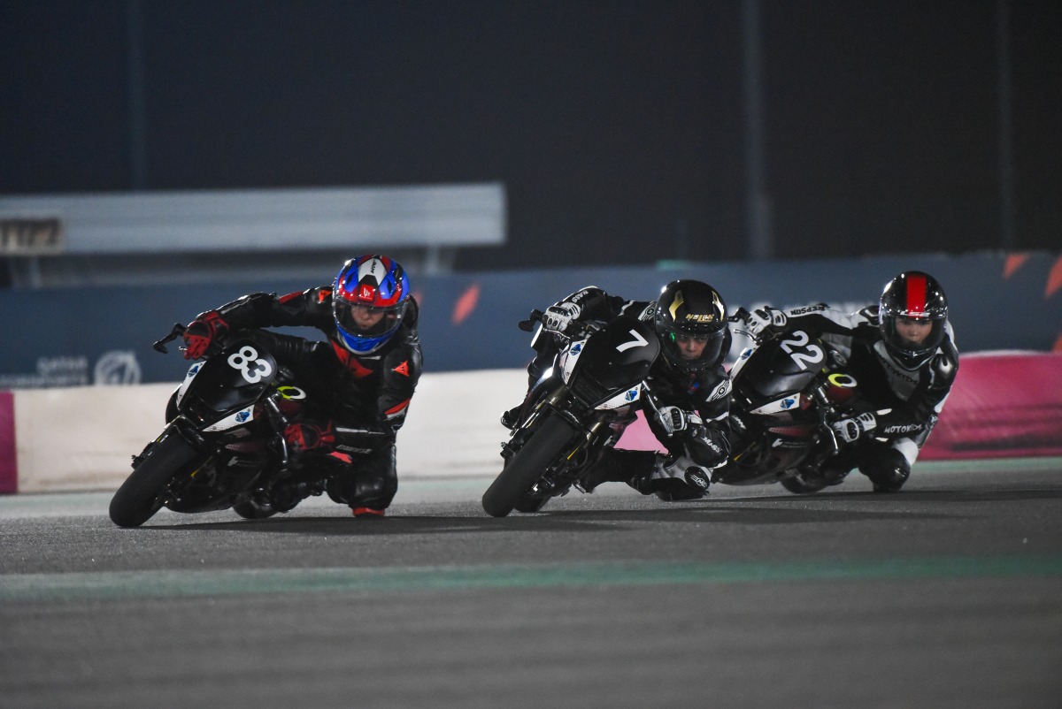 Marton Belleli (left) leads the pack during the final round of the 2024 FIM MiniGP Qatar Championship.