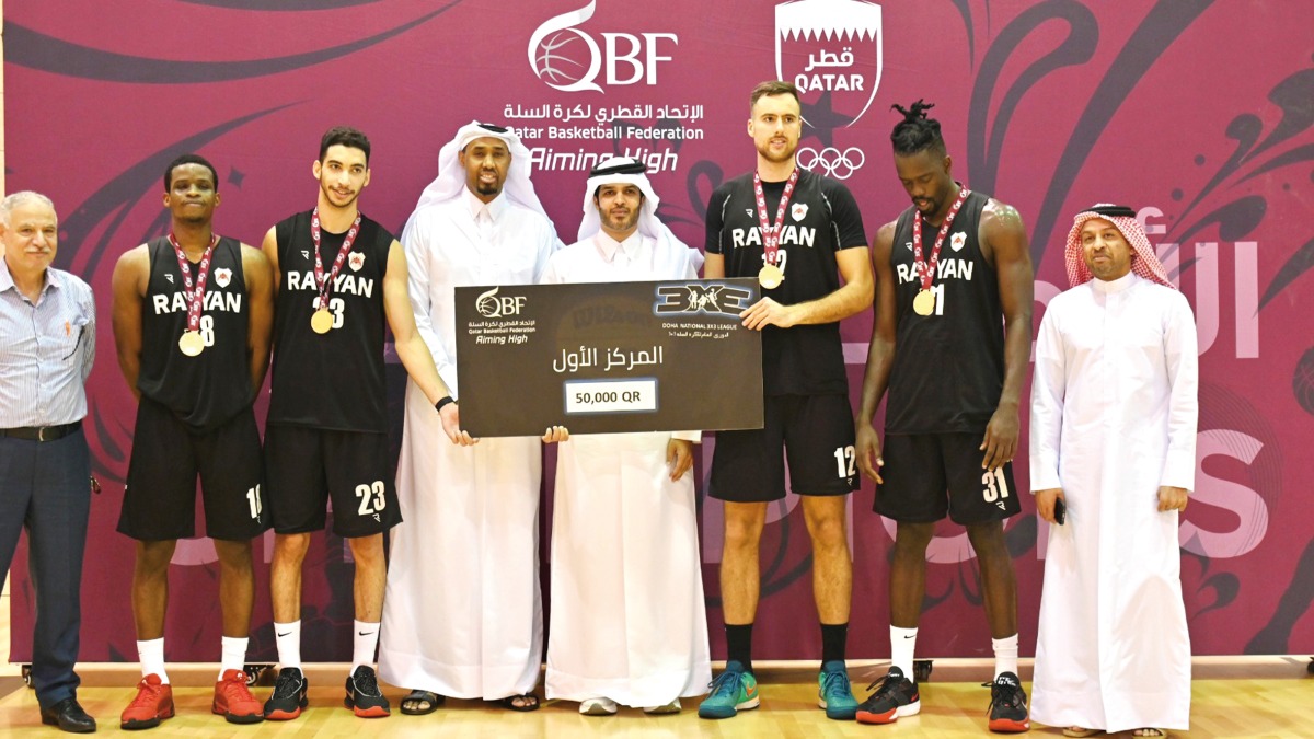 Qatar Basketball Federation President Mohammed bin Saad Al Mughaiseeb with the officials and victorious Al Rayyan players.