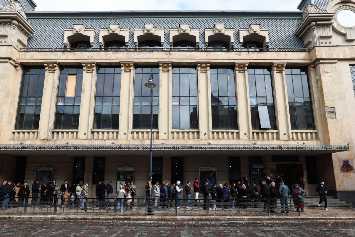 Georgians queue outside a polling station to vote in the country's parliamentary elections in Tbilisi on October 26, 2024. (Photo by Giorgi ARJEVANIDZE / AFP)
