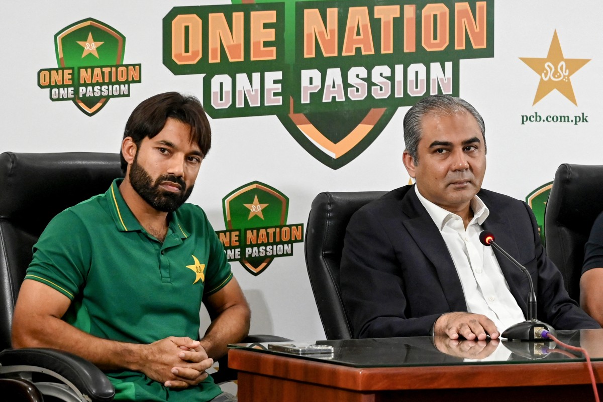 Newly appointed white-ball skipper Mohammad Rizwan (L) and Pakistan Cricket Board chairman Mohsin Naqvi address a press conference in Lahore on October 27, 2024. Pakistan appointed Mohammad Rizwan on October 27, as skipper for the white-ball tours of Australia and Zimbabwe, replacing Babar Azam who stepped down this month. Photo by Arif ALI / AFP.