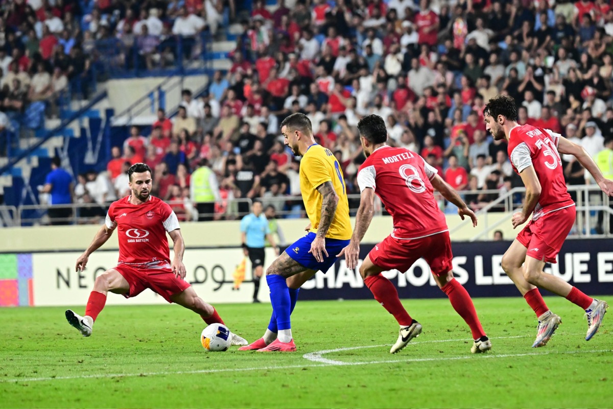 Al Gharafa's Joselu (second left) is challenged by Persepolis players.