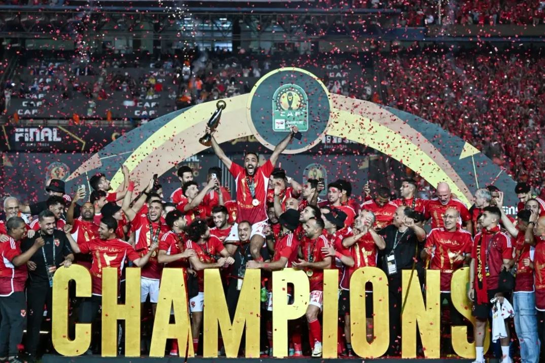 Ahly players celebrate with the winner's trohpy after winning the second leg of the CAF Champions League final football match between Egypt's Al-Ahly and Tunis' Esperance Sportive de Tunis at the Cairo International stadium on May 25, 2024. (Photo by Khaled DESOUKI / AFP)