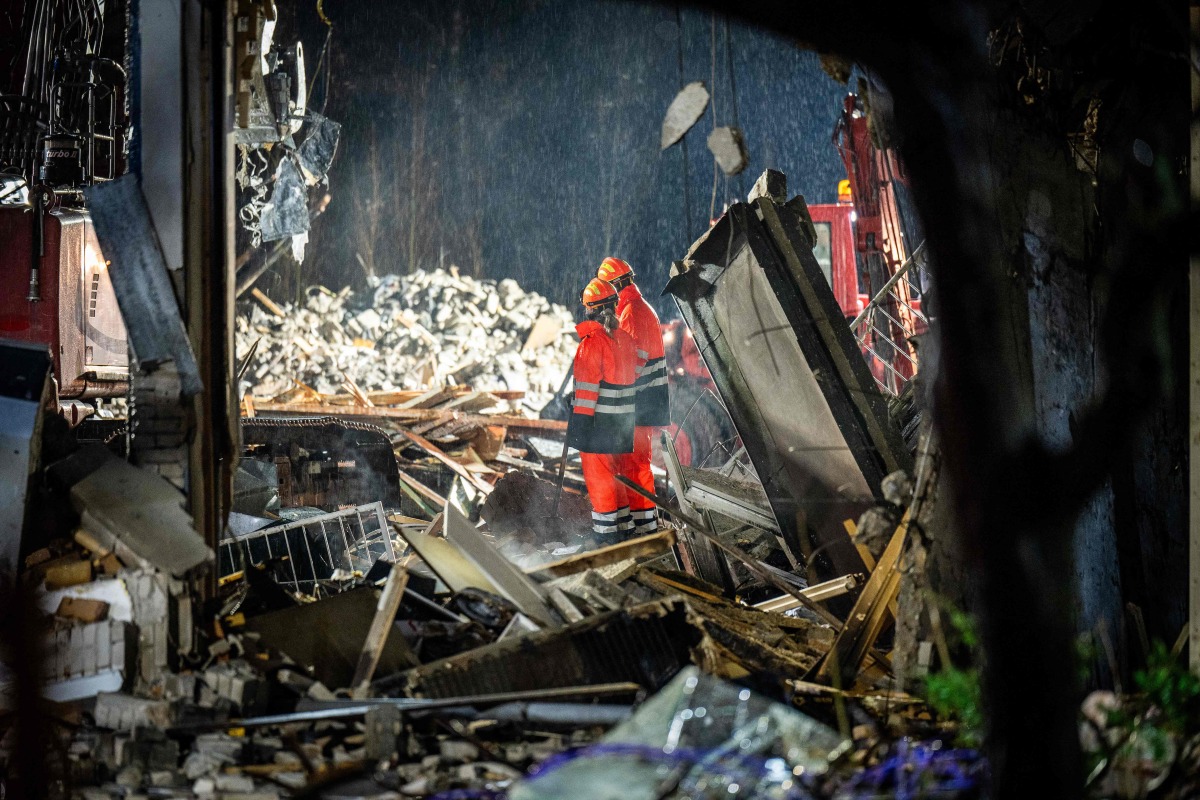 Emergency services search for victims a day after a fire and an explosion that partially collapsed a residential building in The Hague on December 8, 2024. (Photo by Josh Walet / ANP / AFP)
