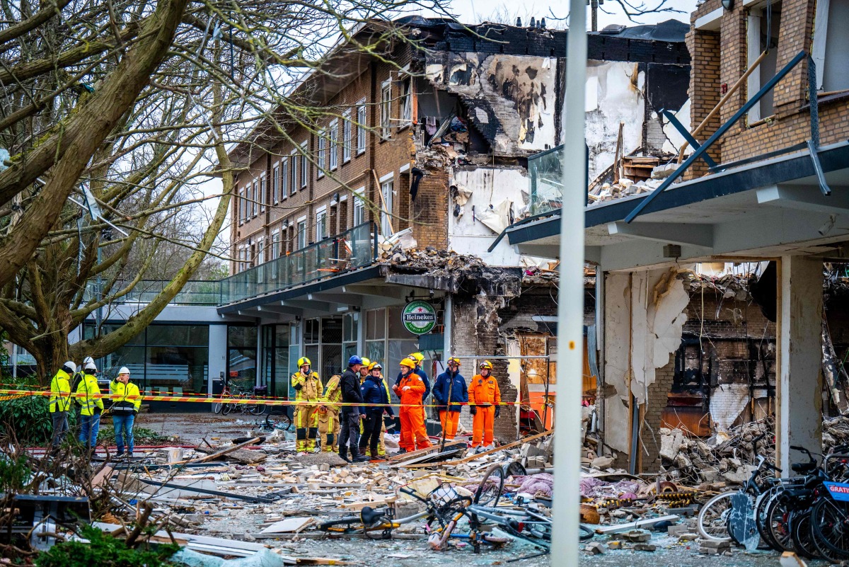 Rescuers work on the site where an explosion and fire destroyed an apartment block, killing at least six people, on the Tarwekamp in The Hague on December 9, 2024. (Photo by Josh Walet / ANP / AFP) / Netherlands OUT
