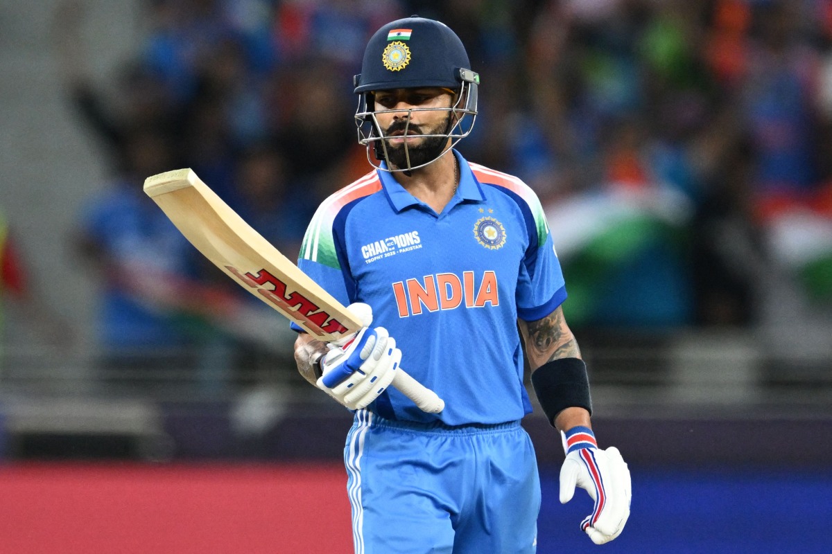 India's Virat Kohli looks at his bat during the ICC Champions Trophy one-day international (ODI) cricket match between Pakistan and India at the Dubai International Stadium in Dubai on February 23, 2025. (Photo by Jewel SAMAD / AFP)
