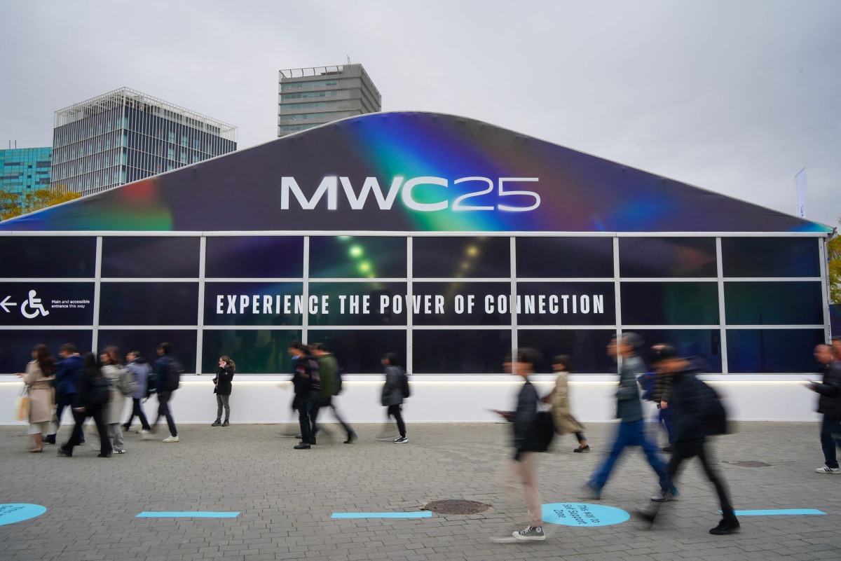 People walk towards the entrance of the MWC (Mobile World Congress), the world's biggest mobile fair, in Barcelona on March 3, 2025. Photo by Manaure QUINTERO / AFP