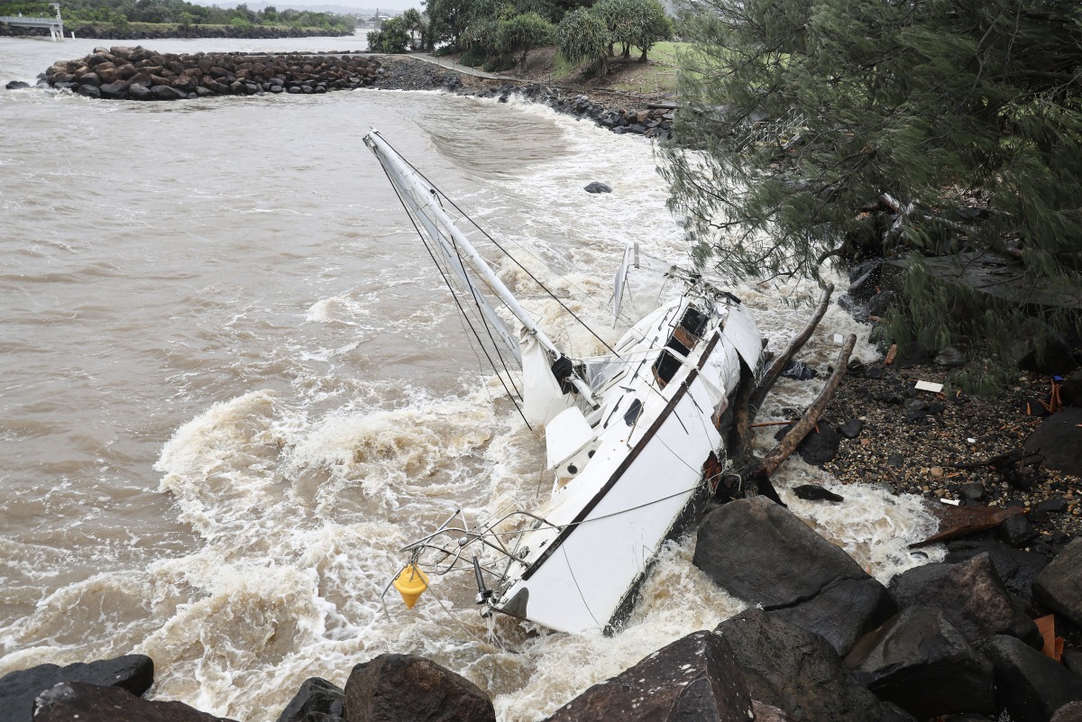 A yacht, swept away by the waves, rests at Point Danger on the southern end of the Gold Coast on March 7, 2025. Photo by David GRAY / AFP
