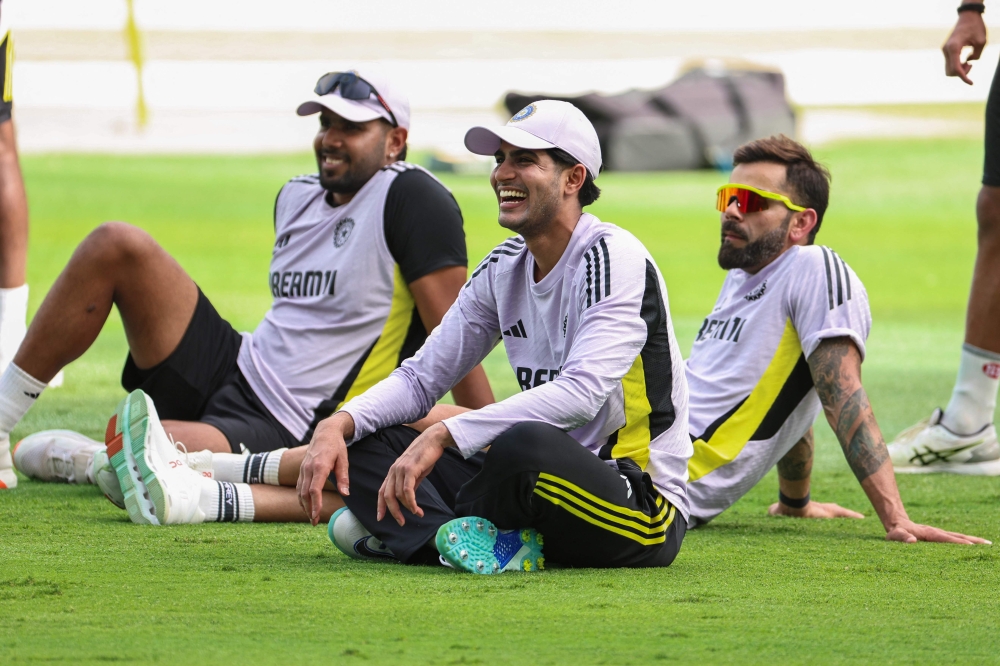 India's Shubman Gill (C) and Virat Kohli (R) join the team during a practice session in Dubai on March 8, 2025. (Photo by Fadel Senna / AFP)