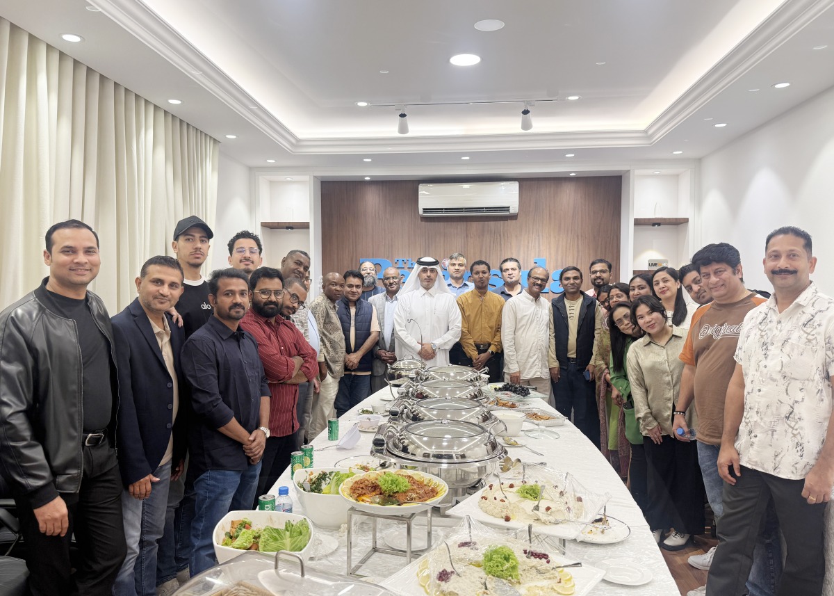 The Peninsula Editor-in-Chief Dr. Khalid Mubarak Al-Shafi with the newspaper's staff during a Ghabga  event yesterday.  