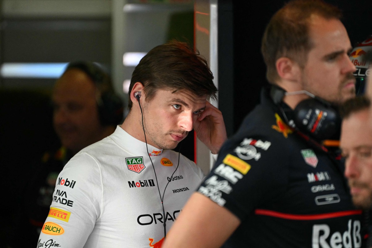 Red Bull Racing's Dutch driver Max Verstappen (L) looks on ahead of the second practice session of the Formula One Australian Grand Prix at the Albert Park Circuit in Melbourne on March 14, 2025. (Photo by Paul Crock / AFP)