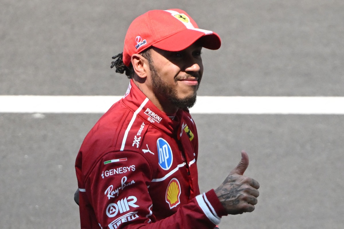 Ferrari's British driver Lewis Hamilton celebrates after winning the sprint race of the Formula One Chinese Grand Prix at the Shanghai International Circuit in Shanghai on March 22, 2025. (Photo by JADE GAO / AFP)