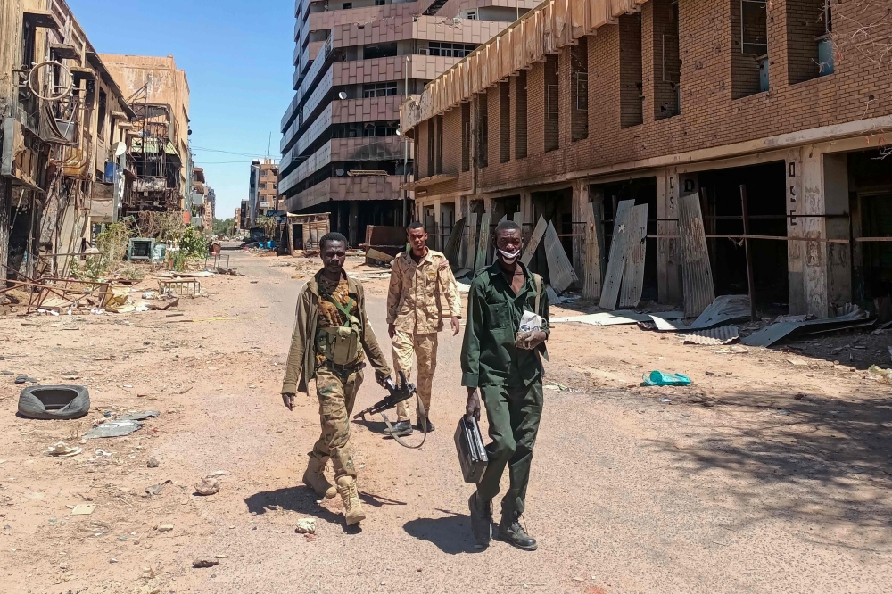 Fighters loyal to the army patrol a market area in Khartoum on March 24, 2025. (Photo by AFP)
